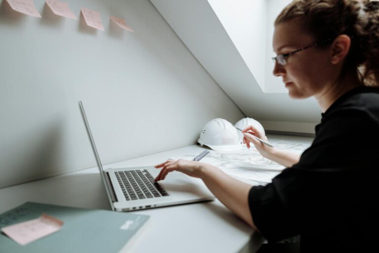 Close-up Photo of Female Architect using Laptop 